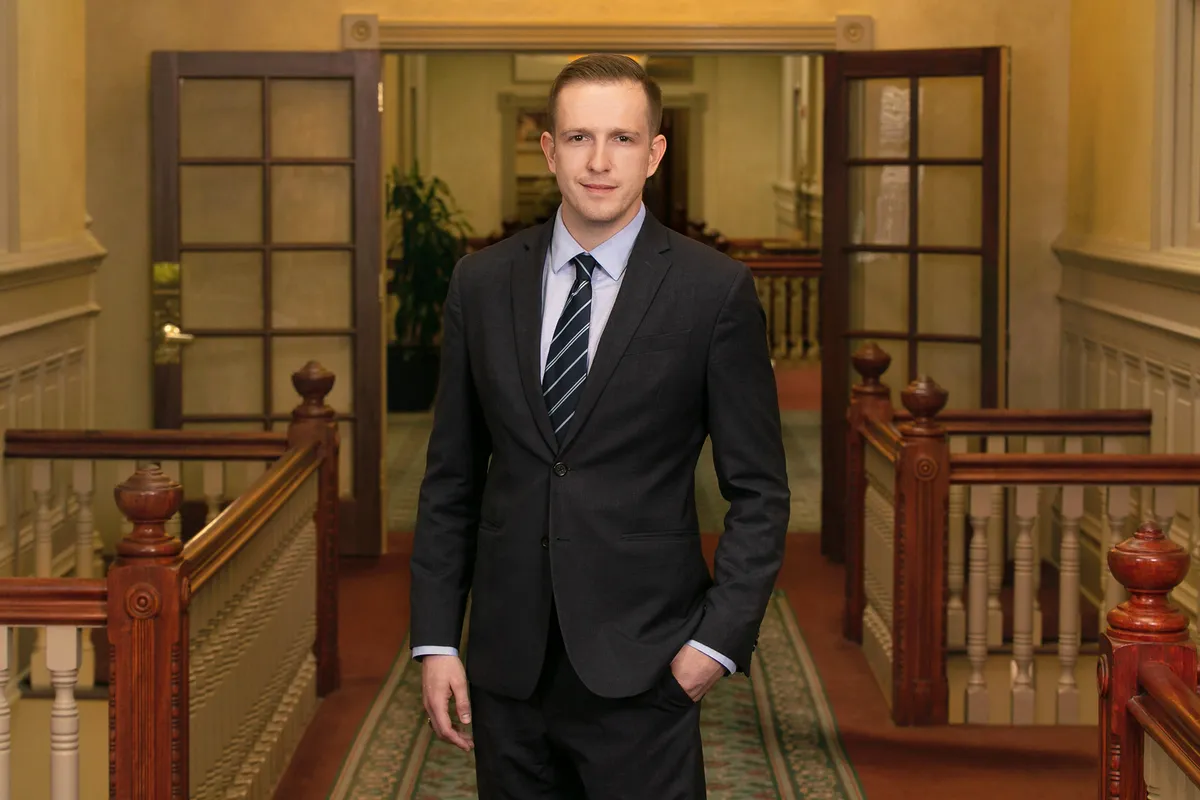 Businessman standing beside a staircase